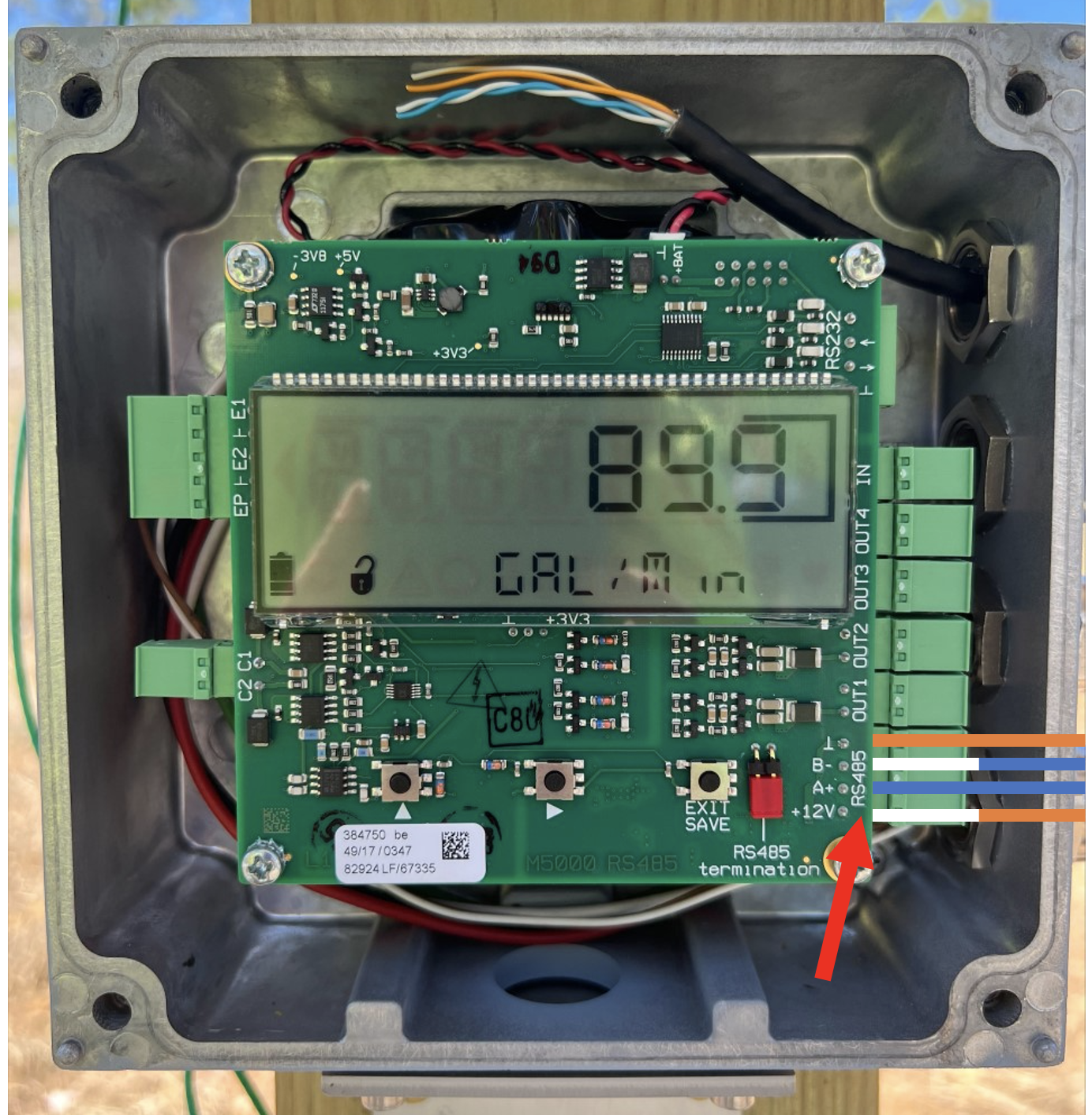 A green electronic device with wires and a displayDescription automatically generated